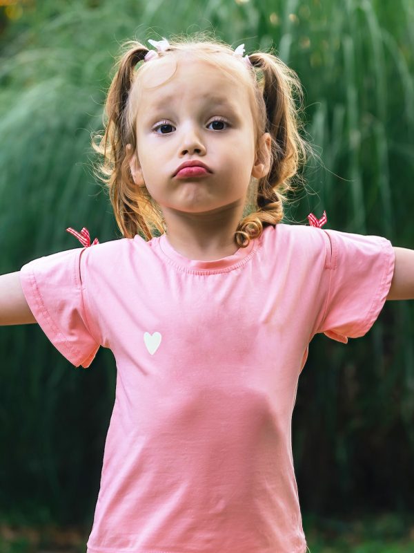 little funny girl shows a gesture with her hands I don't know, I have nothing to do with it